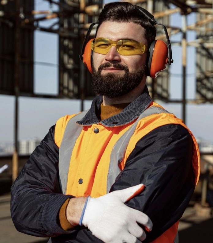 Smiling man wearing protective clothing on a construction site